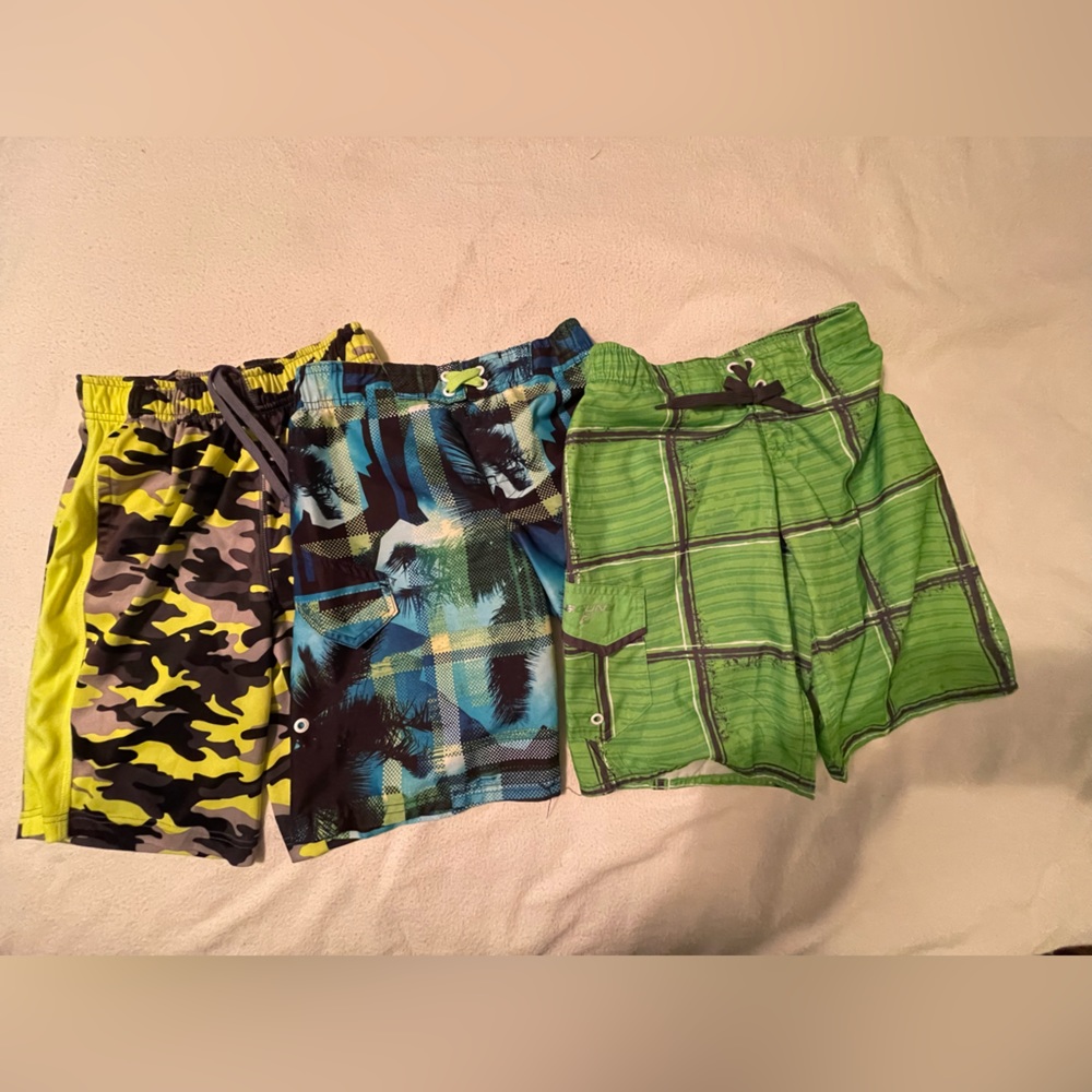 3 pairs boys swim trunks yellow camouflage, blue and green. See description